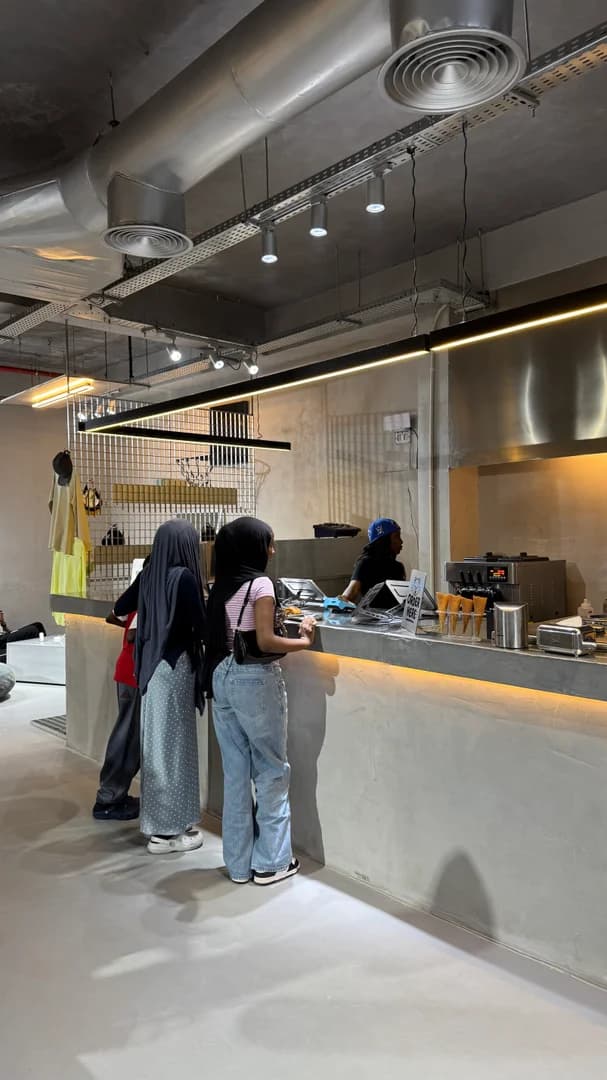 The warm, design-led interior of the Boba Chummy flagship at dusk.